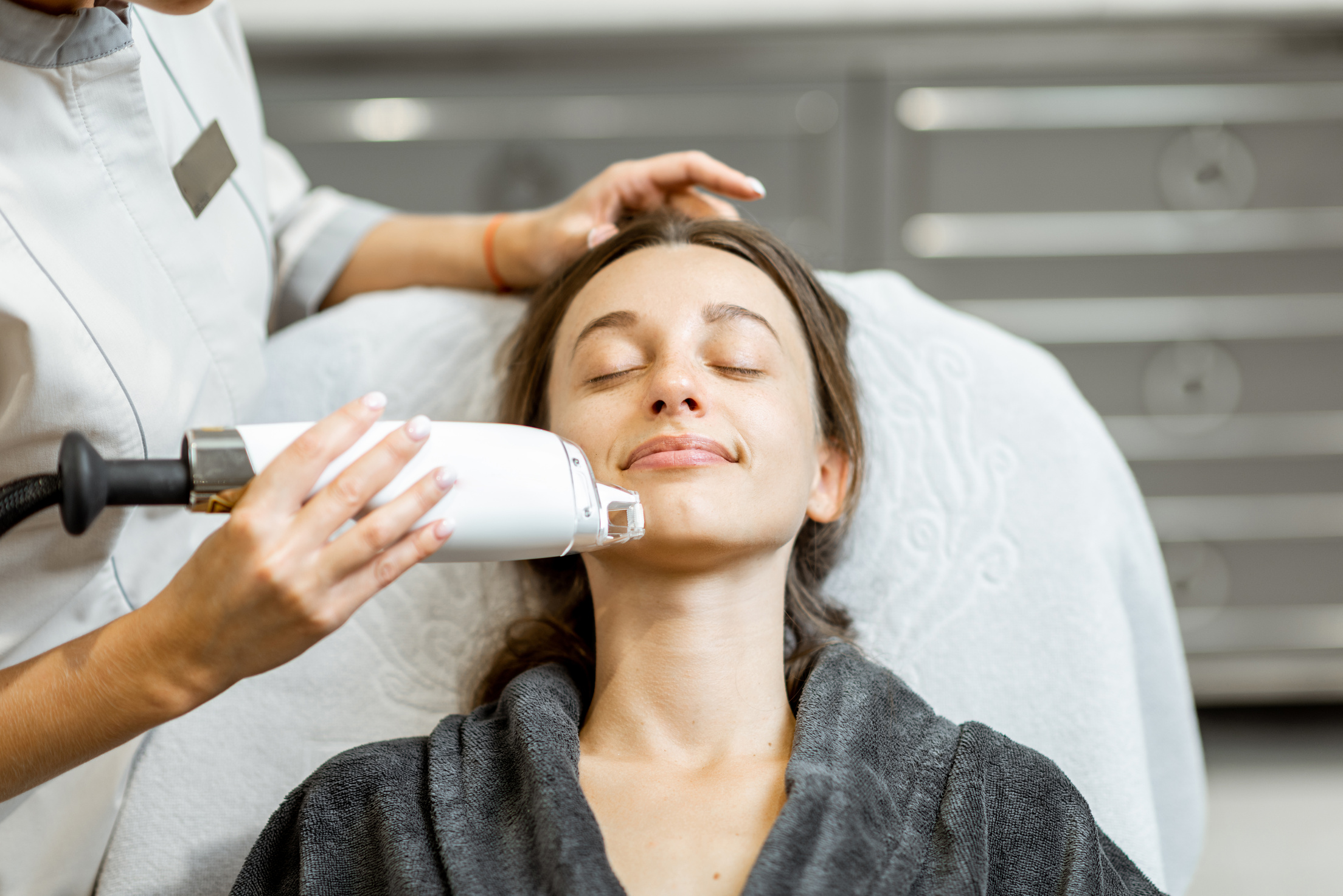 Woman Getting a Face Laser Rejuvenation Treatment at the Spa 